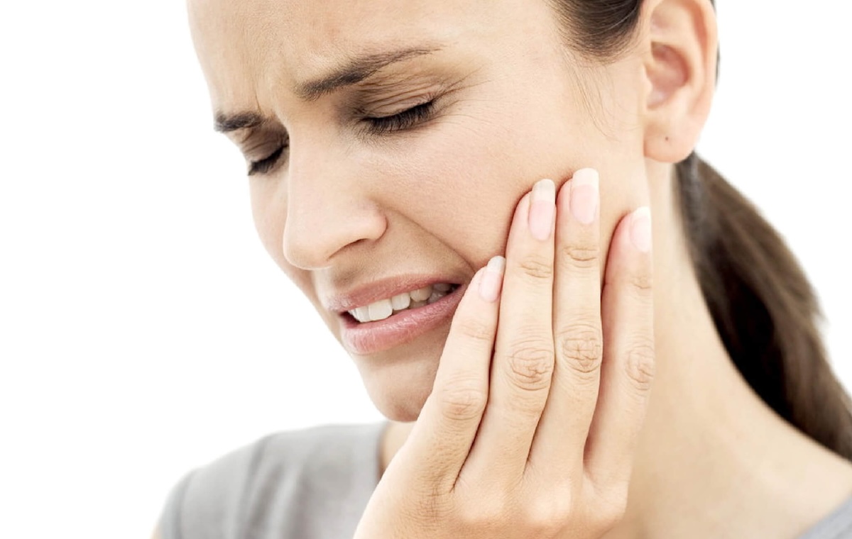 Imatge d'una dona tocant la cara amb dolor